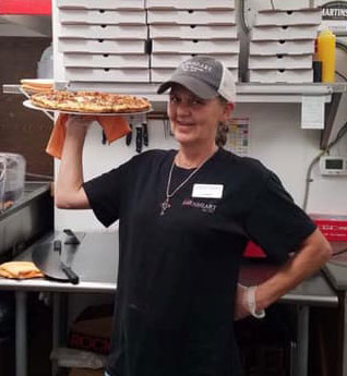 Earnheart Stations Employee Cooking Pizza